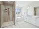 Spacious bathroom with walk-in shower, soaking tub, and dual vanity with white cabinets at 8977 Crossington Way, Lone Tree, CO 80124