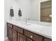 Bathroom featuring a sink with dark wood cabinets and tiled backsplash at 8977 Crossington Way, Lone Tree, CO 80124