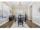 Elegant dining room with hardwood floors, stylish furniture, and natural light at 8977 Crossington Way, Lone Tree, CO 80124