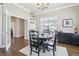 Open dining room with hardwood floors, dark furniture, and adjacent rooms at 8977 Crossington Way, Lone Tree, CO 80124