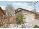 Exterior view of a home with a three-car garage and side yard at 8977 Crossington Way, Lone Tree, CO 80124