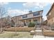 Charming two-story home with stone accents, landscaped yard, and inviting front porch at 8977 Crossington Way, Lone Tree, CO 80124