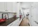 Bright kitchen with white cabinets, modern appliances, and a view into the dining room at 8977 Crossington Way, Lone Tree, CO 80124