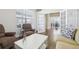 Bright living room featuring hardwood floors, a cozy armchair, and french doors at 8977 Crossington Way, Lone Tree, CO 80124