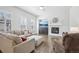 Cozy living room with a fireplace, recessed lighting, and large windows with plantation shutters at 8977 Crossington Way, Lone Tree, CO 80124