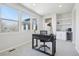 This home office features a built-in wet bar with a beverage cooler, lots of natural light, and plush carpet at 8977 Crossington Way, Lone Tree, CO 80124