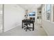 Bright home office space featuring built-in shelving, a fireplace, and neutral walls at 8977 Crossington Way, Lone Tree, CO 80124