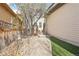 Side yard of home with stone pavers and a small patch of artificial turf at 8977 Crossington Way, Lone Tree, CO 80124