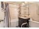 Cozy bathroom featuring a shower-tub combo, dark vanity, and modern fixtures at 1390 W Gill Pl, Denver, CO 80223