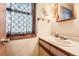 Bathroom featuring a classic sink with white counter and updated faucet, complemented by a mirror and lighting at 1390 W Gill Pl, Denver, CO 80223