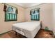 Sunlit bedroom with hardwood floors, ample natural light, and classic window trim at 1390 W Gill Pl, Denver, CO 80223