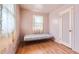 Cozy bedroom with hardwood floors and soft natural light from the window at 1390 W Gill Pl, Denver, CO 80223