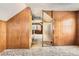 Bedroom featuring paneled walls, frosted glass partition, and a carpeted floor at 1390 W Gill Pl, Denver, CO 80223