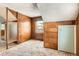 Cozy bedroom featuring paneled walls, built-in drawers and closet, and a window for natural light at 1390 W Gill Pl, Denver, CO 80223