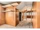 Bedroom featuring paneled walls, open shelving, and a carpeted floor at 1390 W Gill Pl, Denver, CO 80223