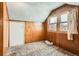 Bedroom with paneled walls, two windows with curtains, and wall to wall carpet at 1390 W Gill Pl, Denver, CO 80223