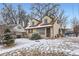 Charming two-story home with a well-maintained front yard covered in fresh snow at 1390 W Gill Pl, Denver, CO 80223