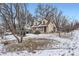 Lovely two-story home with snow-covered yard and mature trees at 1390 W Gill Pl, Denver, CO 80223