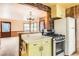 Well-maintained kitchen with tiled floor, brick accents, and a view to the living area at 1390 W Gill Pl, Denver, CO 80223