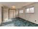 Bedroom with light patterned walls, blue carpet, and double closet doors at 315 E 112Th Dr, Northglenn, CO 80233