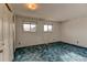 Bedroom with light patterned walls, blue carpet, and a pair of windows at 315 E 112Th Dr, Northglenn, CO 80233