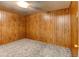 Bedroom with wood walls, light carpet, and door at 315 E 112Th Dr, Northglenn, CO 80233