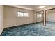 Bedroom with light patterned walls, blue carpet, window, and mirrored closet doors at 315 E 112Th Dr, Northglenn, CO 80233