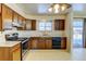 Functional kitchen featuring an oven, wood cabinets, and plenty of counter space at 315 E 112Th Dr, Northglenn, CO 80233