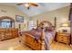 Bright bedroom featuring a large bed and wood furniture at 6460 E 165Th Ct, Brighton, CO 80602