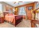 Bedroom with a queen-size bed and an orange color scheme at 6460 E 165Th Ct, Brighton, CO 80602