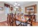 Formal dining room, hardwood floors, and a large wood table with seating for six at 6460 E 165Th Ct, Brighton, CO 80602