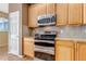 Well-equipped kitchen featuring stainless steel appliances and wood cabinets at 6460 E 165Th Ct, Brighton, CO 80602