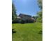 Spacious backyard with lush green lawn and mature trees at 4827 S Lewis Ct, Littleton, CO 80127