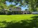 Spacious backyard with lush green lawn and mature trees at 4827 S Lewis Ct, Littleton, CO 80127