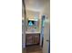 Bathroom featuring a wooden vanity with a mirror and towel rack at 4827 S Lewis Ct, Littleton, CO 80127