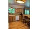 Well-lit kitchen features wood cabinets, stone countertops, and a breakfast bar at 4827 S Lewis Ct, Littleton, CO 80127
