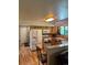 Kitchen featuring stainless steel appliances, wood cabinetry and hardwood floors at 4827 S Lewis Ct, Littleton, CO 80127