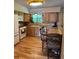 Bright kitchen features stainless steel appliances, wood cabinetry, and an eat-in bar at 4827 S Lewis Ct, Littleton, CO 80127