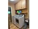 Functional laundry room with storage cabinets and modern washer and dryer at 4827 S Lewis Ct, Littleton, CO 80127