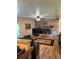 Inviting living room features a brick fireplace, hardwood floors and a ceiling fan at 4827 S Lewis Ct, Littleton, CO 80127