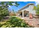 Inviting backyard features a covered patio and well-manicured lawn, ideal for outdoor living at 24394 E Dorado Pl, Aurora, CO 80016