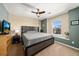 Cozy bedroom with neutral tones, ceiling fan, and a large window letting in natural light at 24394 E Dorado Pl, Aurora, CO 80016
