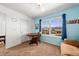 Bedroom features bright blue walls, a desk, and a large window at 24394 E Dorado Pl, Aurora, CO 80016
