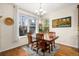 Bright dining room featuring wood floors, large windows and contemporary chandelier at 24394 E Dorado Pl, Aurora, CO 80016