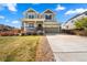 Beautiful two-story home with a well-maintained lawn and a two-car garage at 24394 E Dorado Pl, Aurora, CO 80016