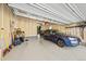 Attached garage with space for vehicle and storage; epoxy floor and painted walls at 24394 E Dorado Pl, Aurora, CO 80016