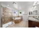 Bright main bathroom featuring glass enclosed shower, soaking tub, and double vanity at 24394 E Dorado Pl, Aurora, CO 80016