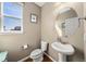 Neat half bathroom featuring pedestal sink, oval mirror, and updated fixtures at 24394 E Dorado Pl, Aurora, CO 80016