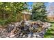 A serene water feature adds tranquility to the landscaped backyard with natural stone and flowing water at 24394 E Dorado Pl, Aurora, CO 80016