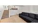 Basement featuring neutral tones, a large sectional couch, and stairs to the upper level at 4860 S Salida Ct, Aurora, CO 80015
